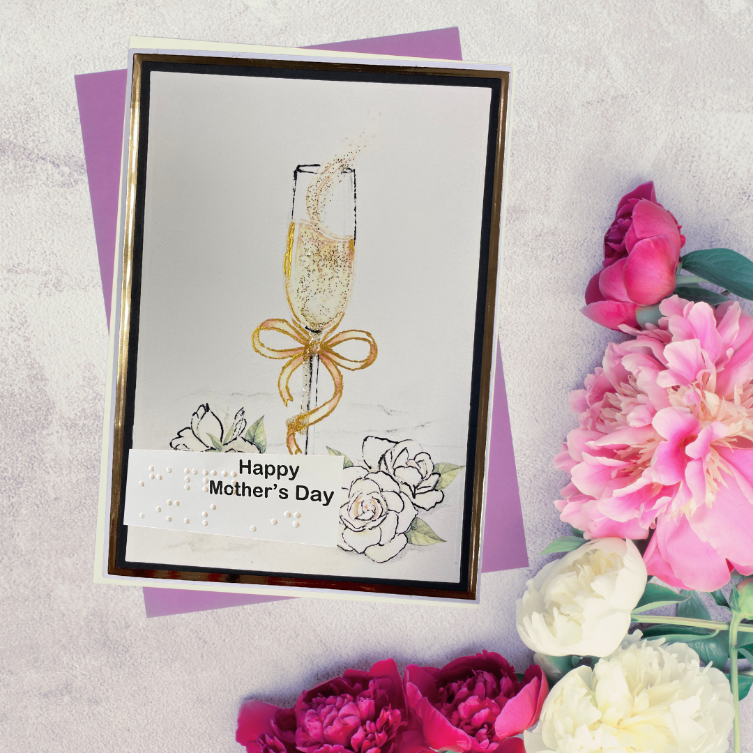 Greeting card with champagne glass and flowers on a textured surface with flowers around