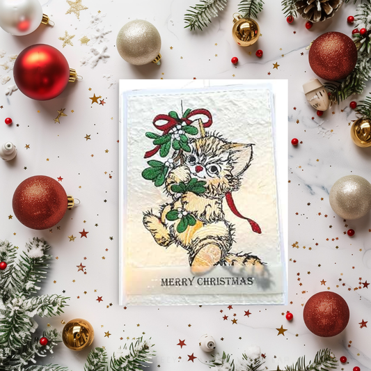 Christmas card with a kitten surrounded by festive decorations on a white background
