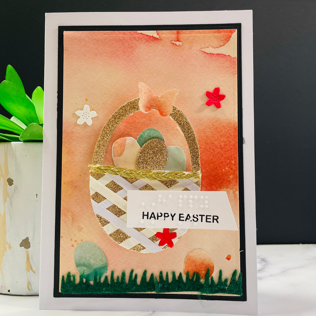 Handmade Easter card with decorative elements and 'Happy Easter' text on a black background.