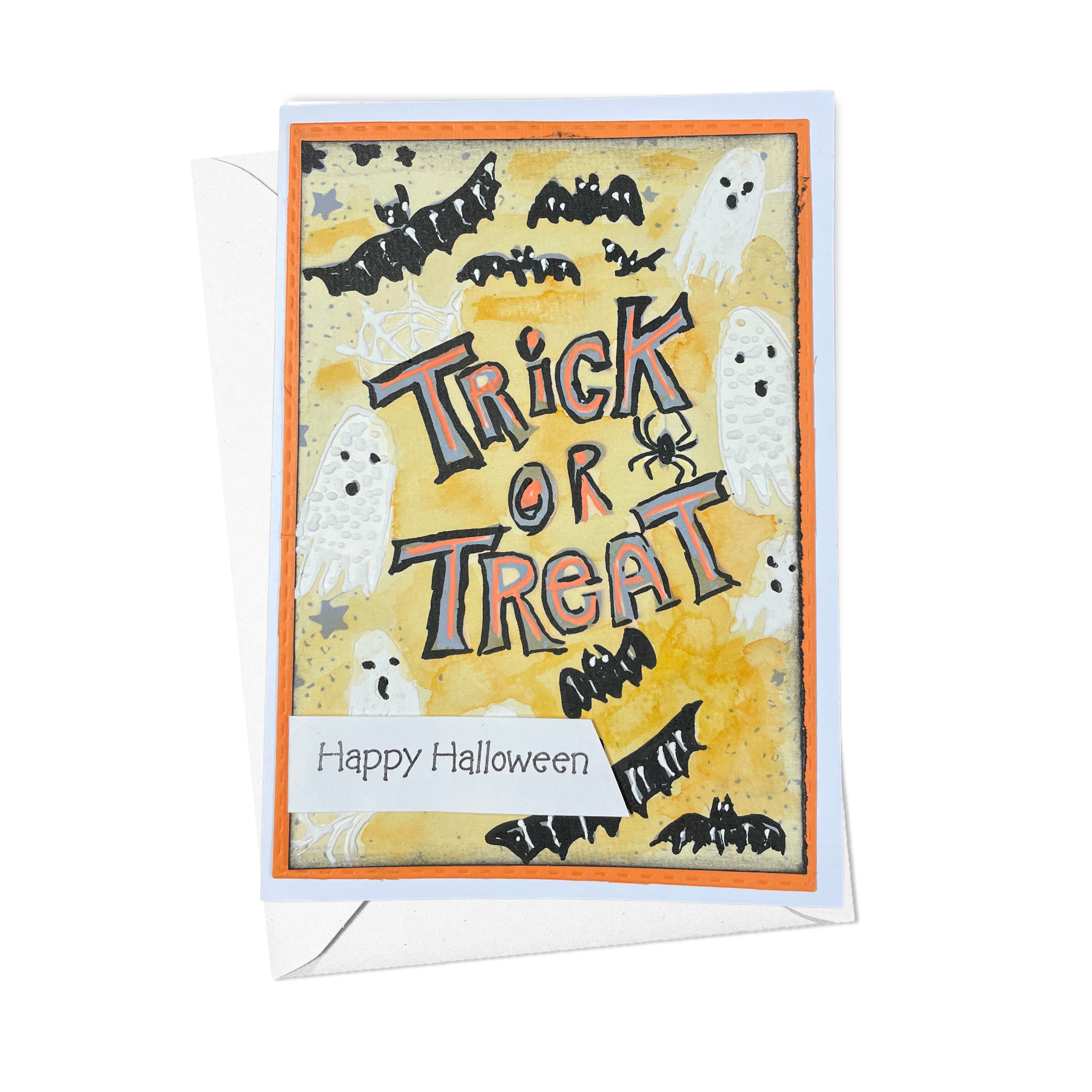 A Halloween greeting card with a white envelope, featuring a yellow background with spooky illustrations of ghosts, bats, and a spider, and the words 'Trick or Treat' and 'Happy Halloween'.