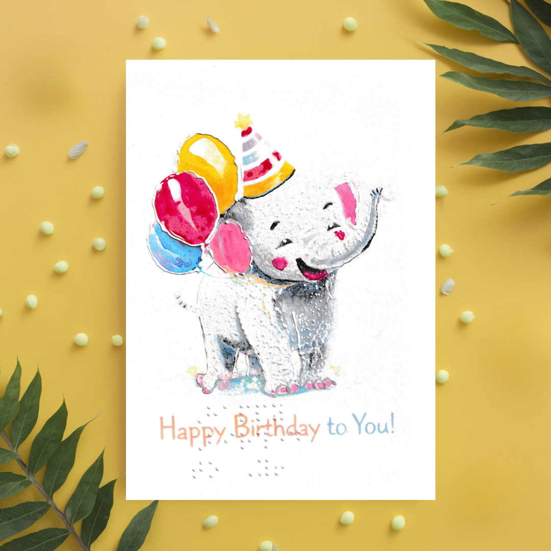 Birthday card with a cartoon elephant wearing a party hat on a yellow background