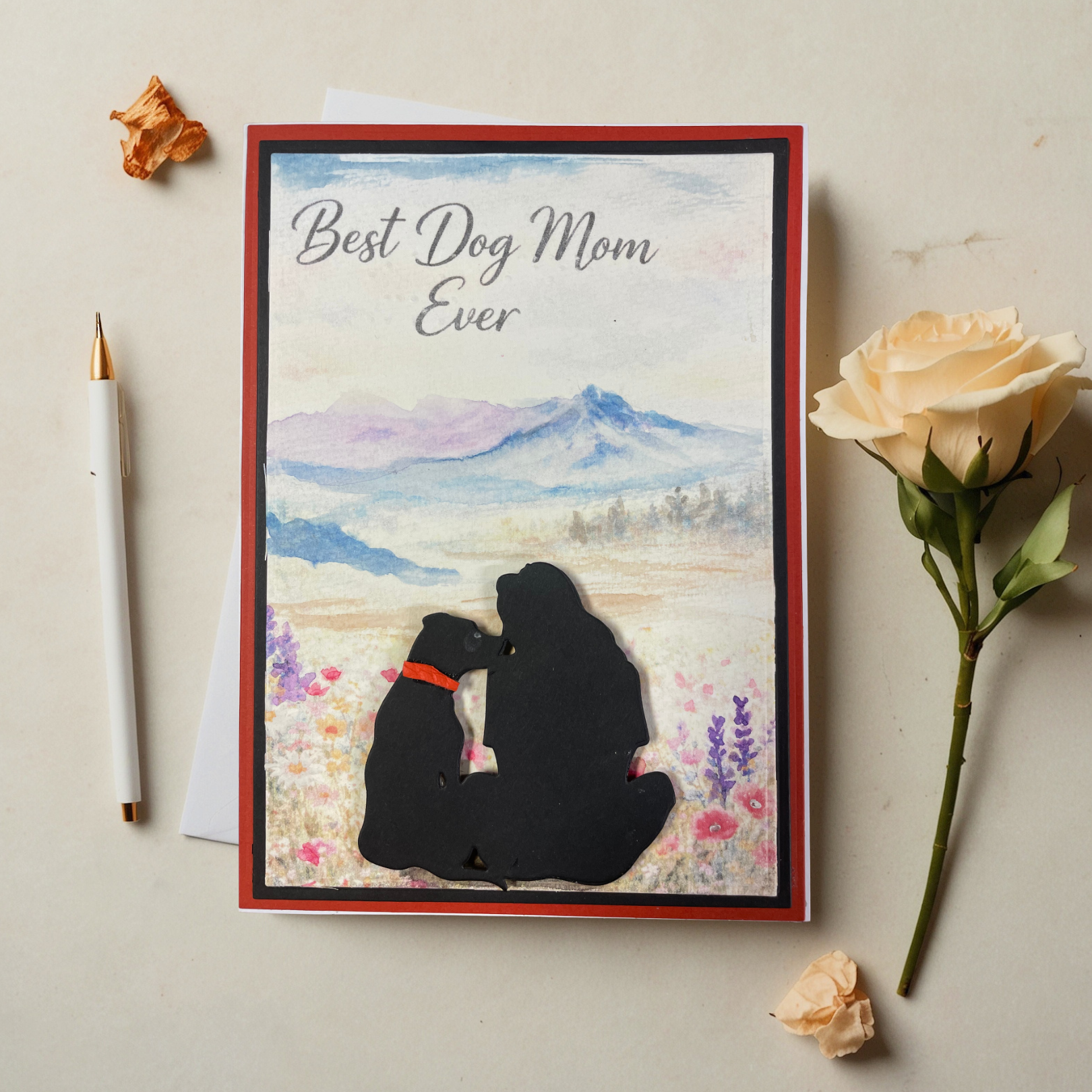 Greeting card for 'Best Dog Mom Ever' with a silhouette of a dog and its owner, flowers, and mountains.