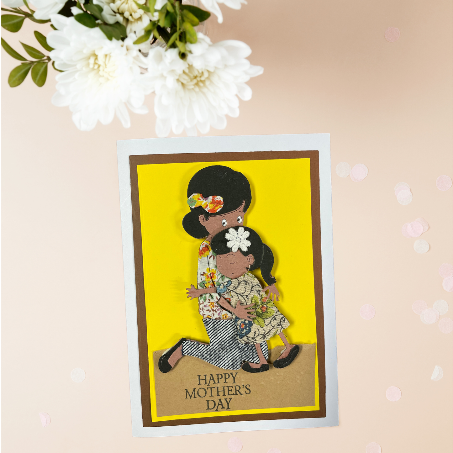 Mother's Day card with a tactile image of a mother and daughter on a yellow background