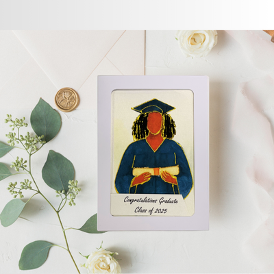 Graduation-themed card with a portrait of a graduate on a white surface with greenery.
