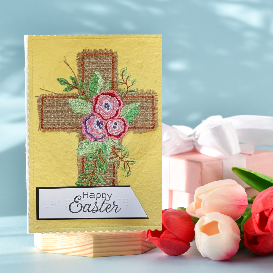 Easter card with cross and flowers on table with a gift box and flowers