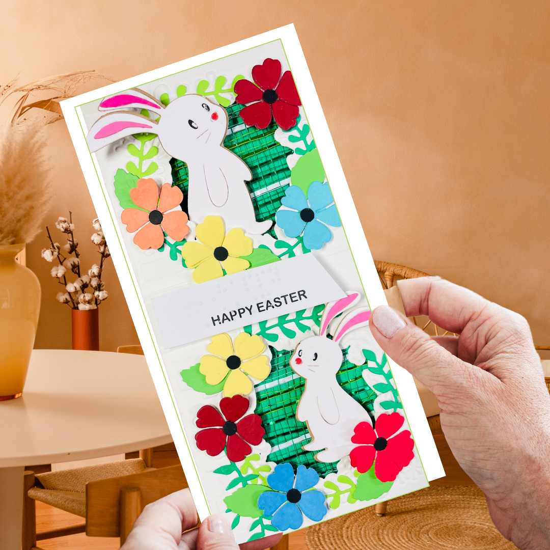 Hand holding a colorful Easter card with bunnies and flowers 