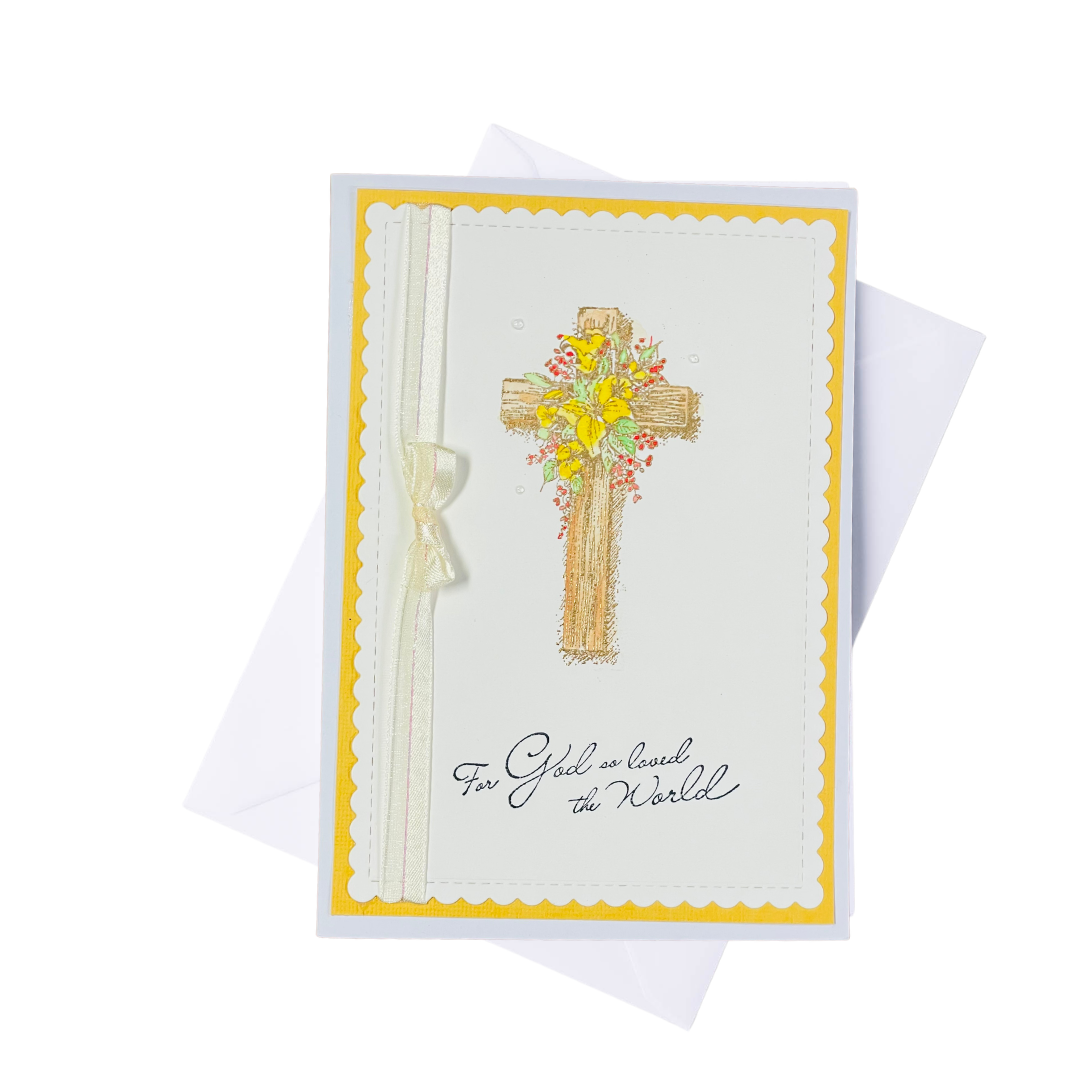 Greeting card with a cross design and floral elements, a ribbon on a white background