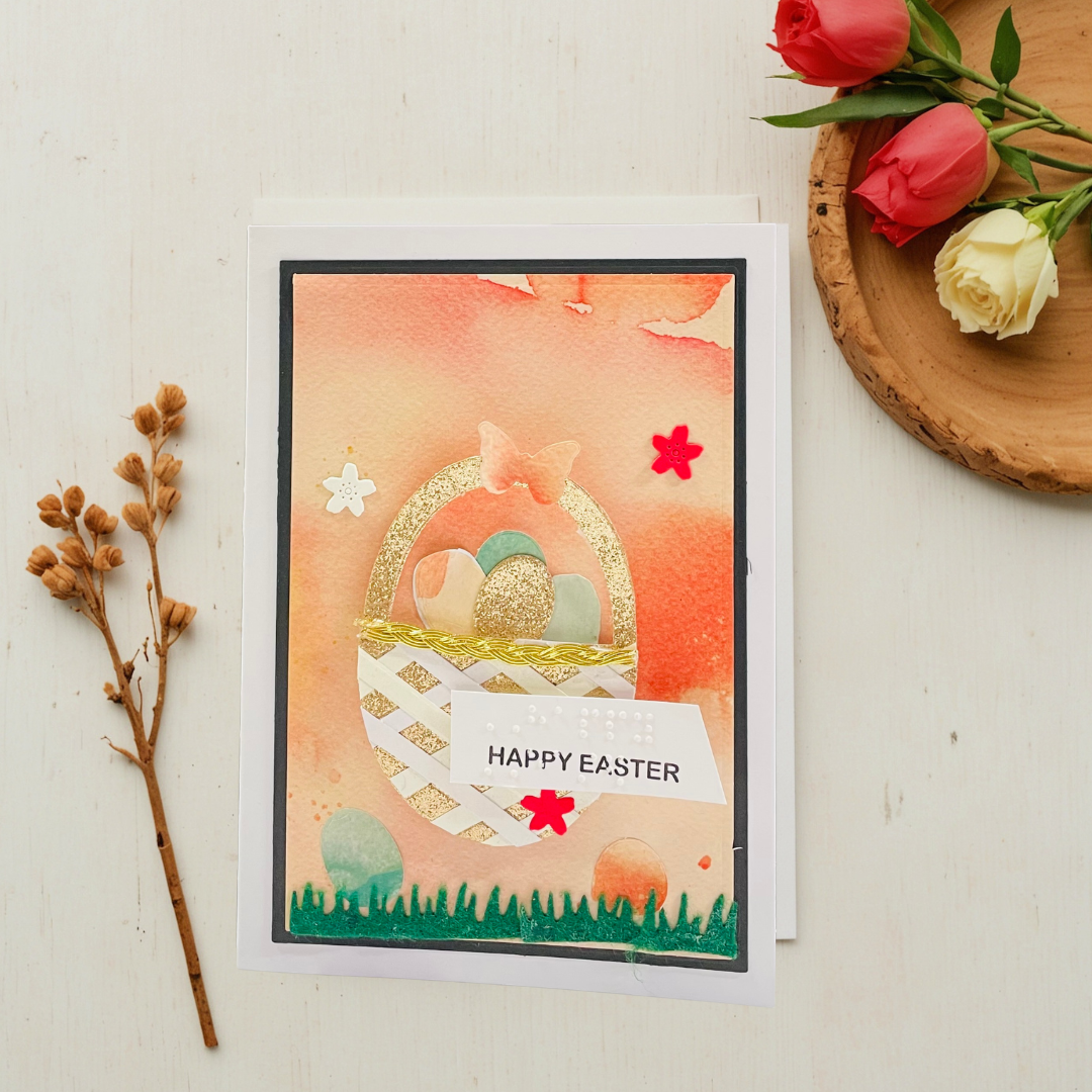 Easter card with decorative elements on a light surface with flowers and twigs.
