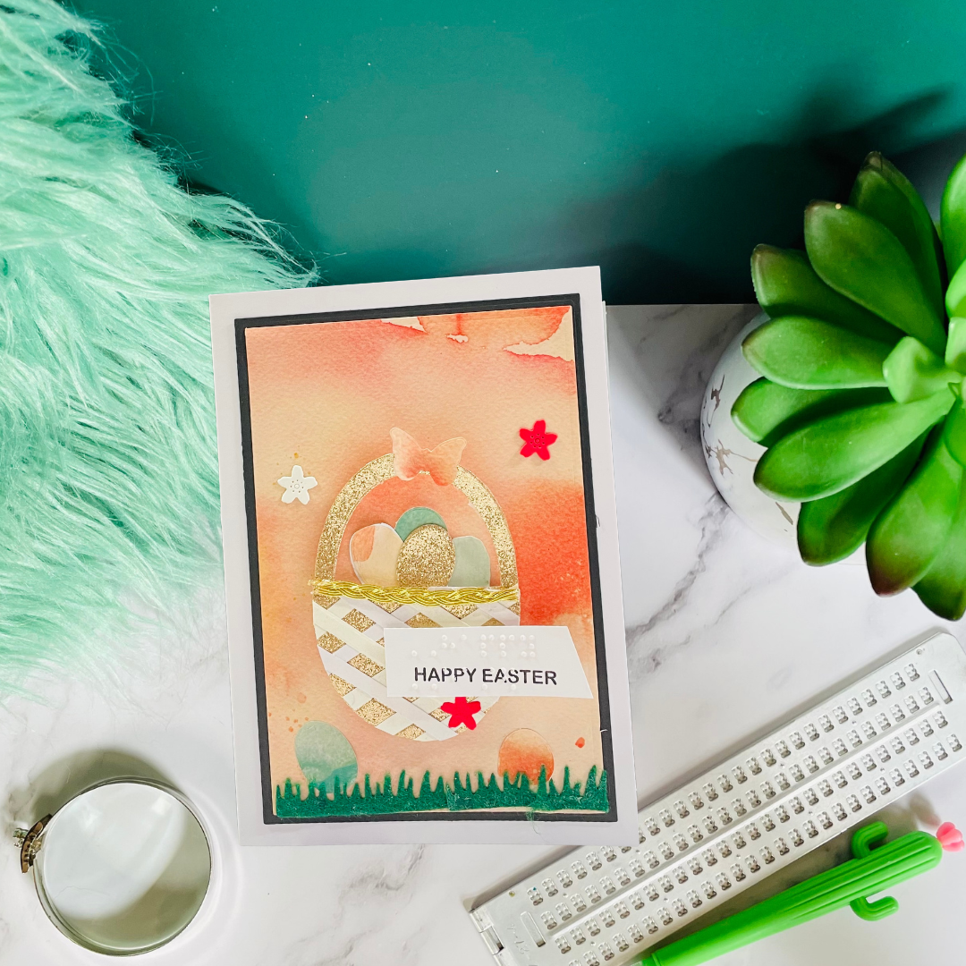 Easter card with decorative elements on a marble surface with a plant and candle.