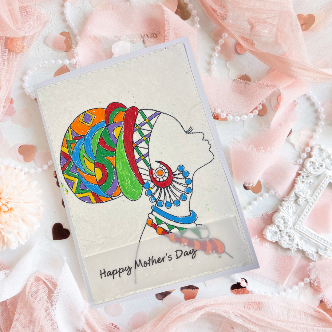 Mother's Day card features a hand-drawn profile silhouette of a woman adorned with a vivid geometric head wrap in orange, red, green, blue, and purple, paired with layered statement jewelry in matching jewel tone Mother's Day card with a stylized silhouette of a woman on a decorative background.