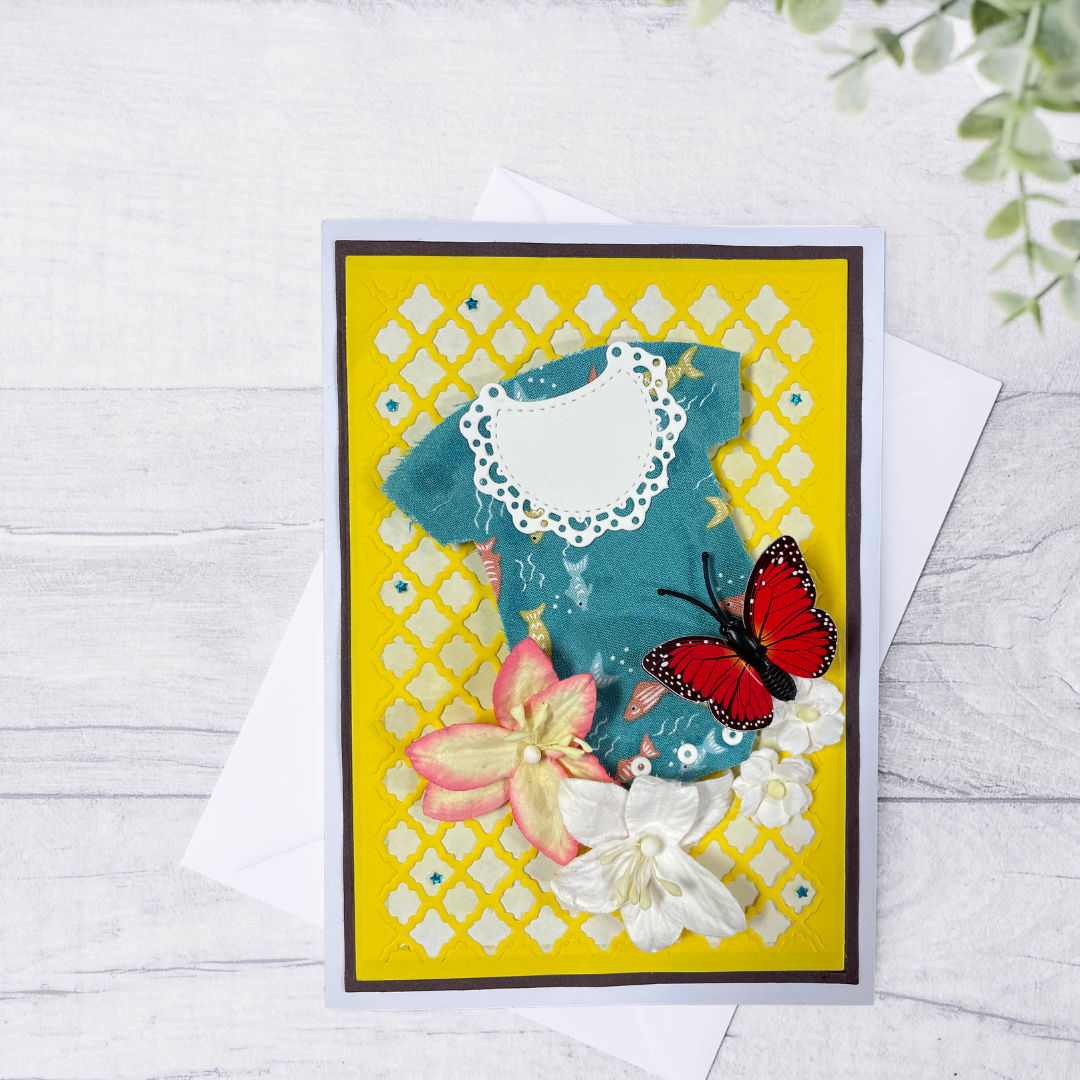 Decorative card with flowers and a butterfly on a yellow lattice Handmade boxed Mother’s Day greeting cards for a new mom, featuring a baby outfit design, layered flowers, butterfly embellishments