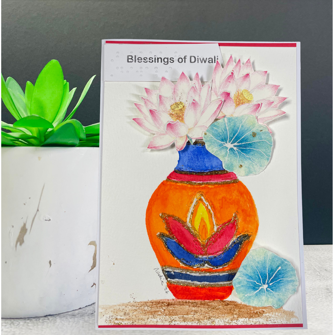 Handmade Blessings of Diwali greeting card displayed beside a plant.