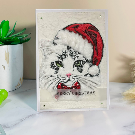 Christmas-themed card with a cat wearing a Santa hat and text 'Merry Christmas' on a light background.