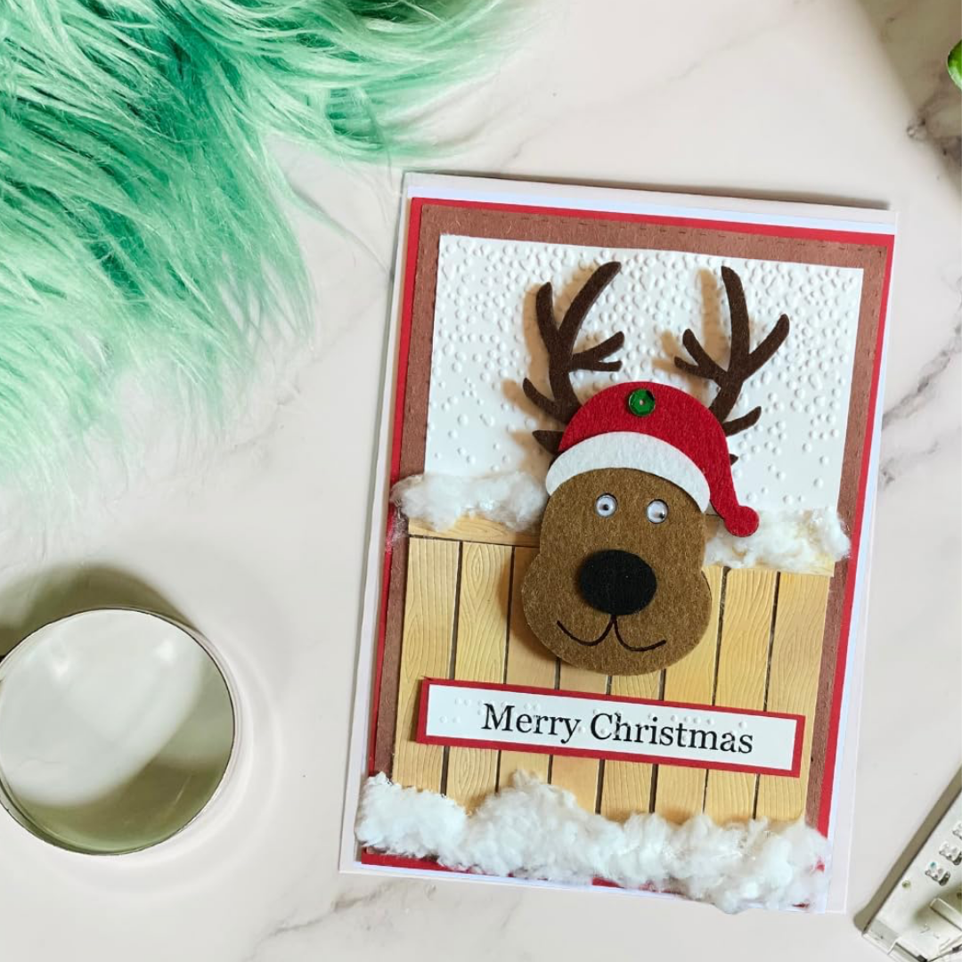 Braille Christmas Greeting Card – Festive Reindeer at Fence