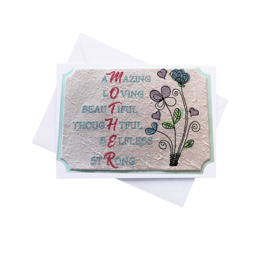 Greeting card with embroidered text and floral design on a white background