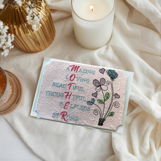 Greeting card with floral design and text on a soft fabric background