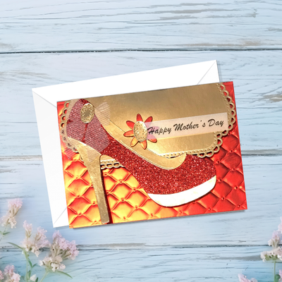 Greeting card with high-heeled shoe design and 'Happy Mother's Day' text on a wooden surface.