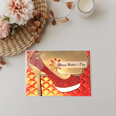 Greeting card with high-heeled shoe design and 'Happy Mother's Day' text on a decorative surface.