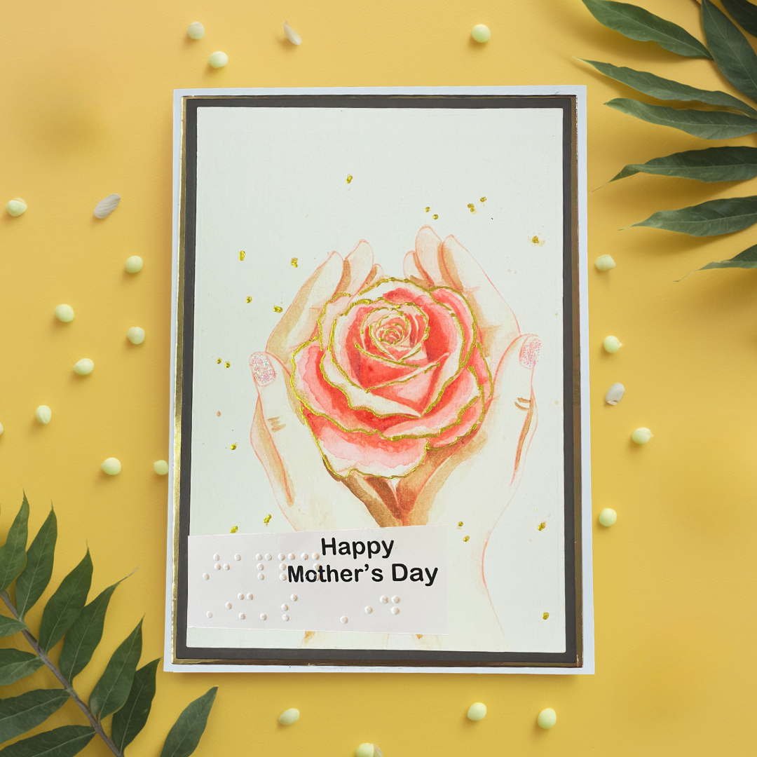 Greeting card with a pink rose and hands on a yellow background with decorative elements.