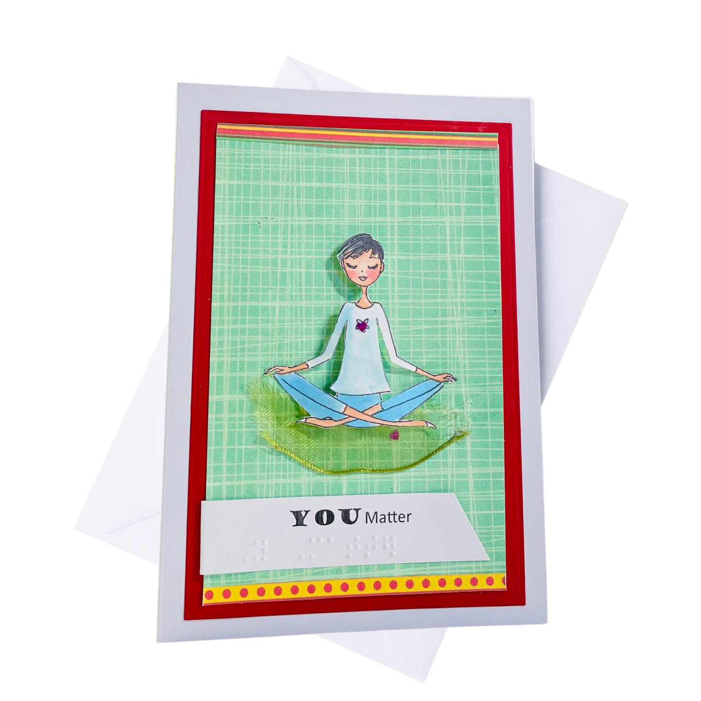 A handmade greeting card with a white border, featuring a green grid background, a red inner border, and a cartoon illustration of a person meditating. The card includes a white banner reading 'YOU Matter' and is shown with a white envelope behind it on a white background.