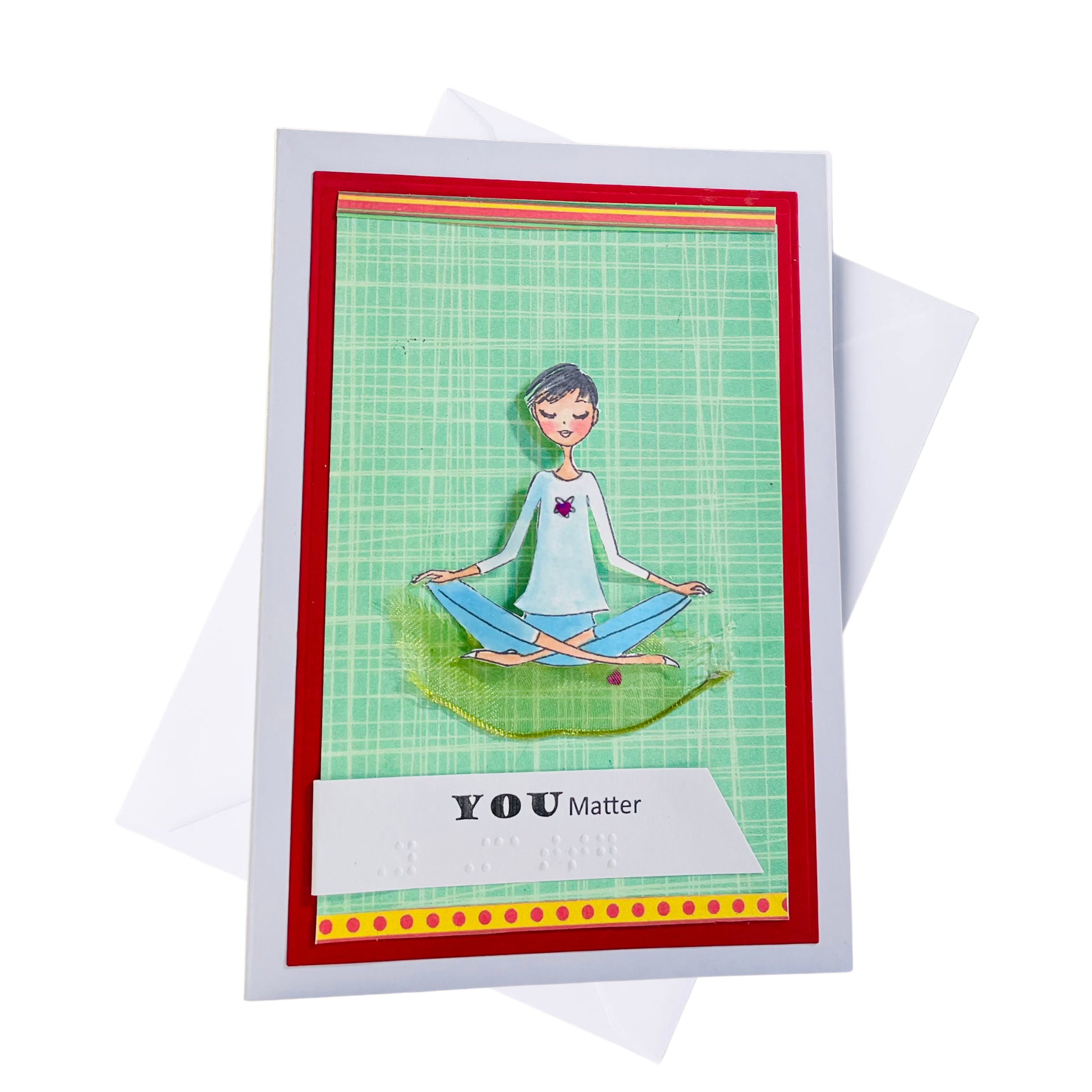 A handmade greeting card with a white border, featuring a green grid background, a red inner border, and a cartoon illustration of a person meditating. The card includes a white banner reading 'YOU Matter' and is shown with a white envelope behind it on a white background.