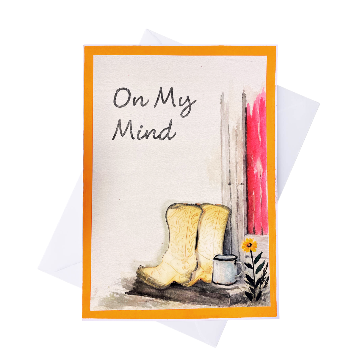 A handmade greeting card with an orange border, featuring the text and braille  'On My Mind' above a watercolor of beige cowboy boots, a small white cup, and a yellow flower against a off white background.